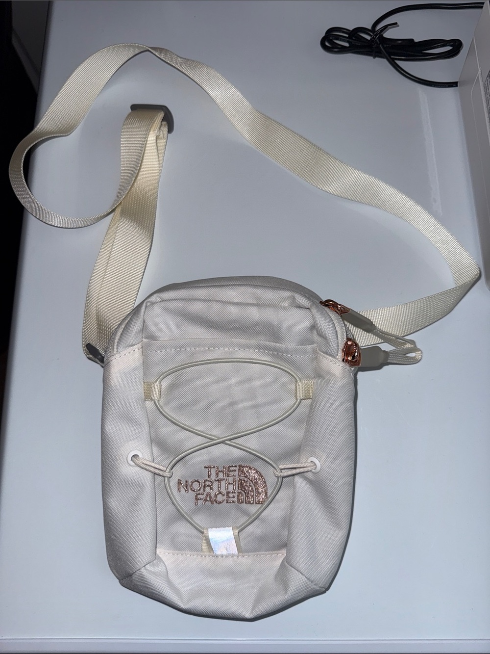 The North Face Cream Crossbody Bag with Rose Gold Accents